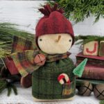 Handmade winter wool snowman shelf sitter, rustic farmhouse Christmas décor with red hat, green sweater, scarf, carrot nose, and snowflake accent