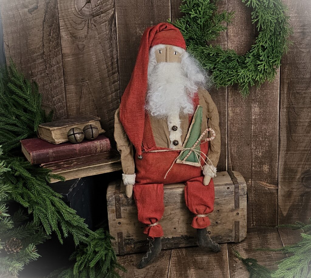 Handmade primitive vintage folk art Santa Claus, rustic farmhouse Christmas décor with wool beard and quilted accent.