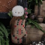 Handmade primitive snowman in vintage coverlet mitten, rustic farmhouse Christmas décor with wool scarf, berries, and pine sprigs