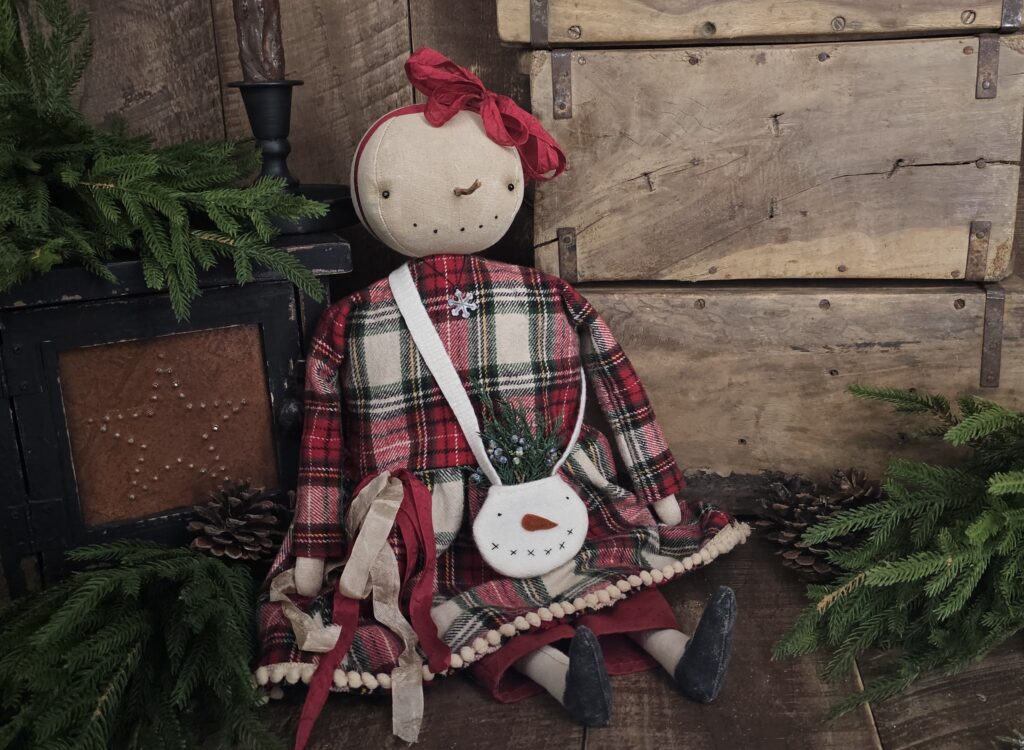 Handmade primitive snowman doll, rustic farmhouse Christmas décor shelf sitter with flannel dress, carrot nose, and stitched smile