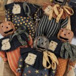 Rustic Halloween pumpkin shelf sitter with twig arms and legs