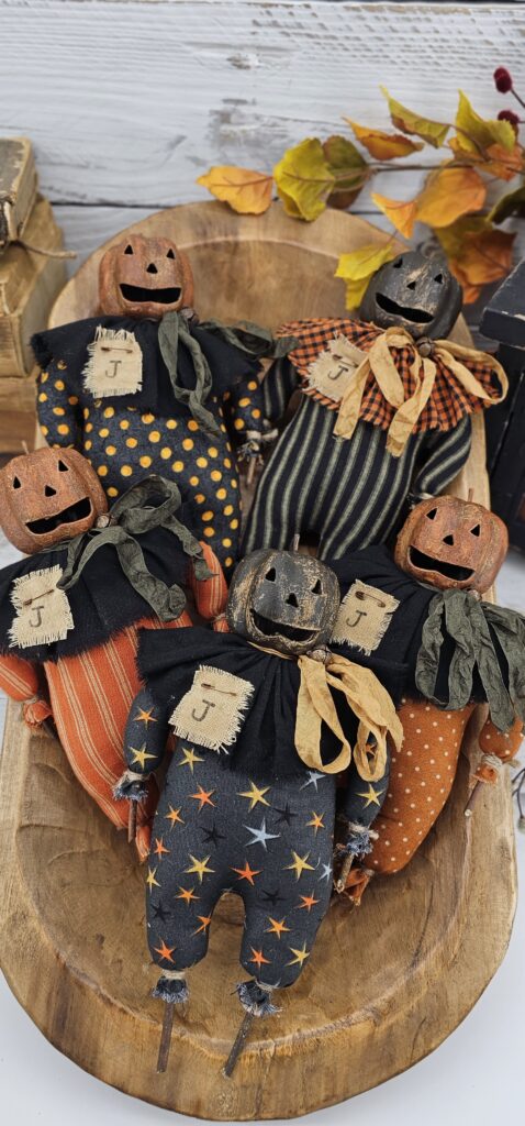 Rustic Halloween pumpkin shelf sitter with twig arms and legs