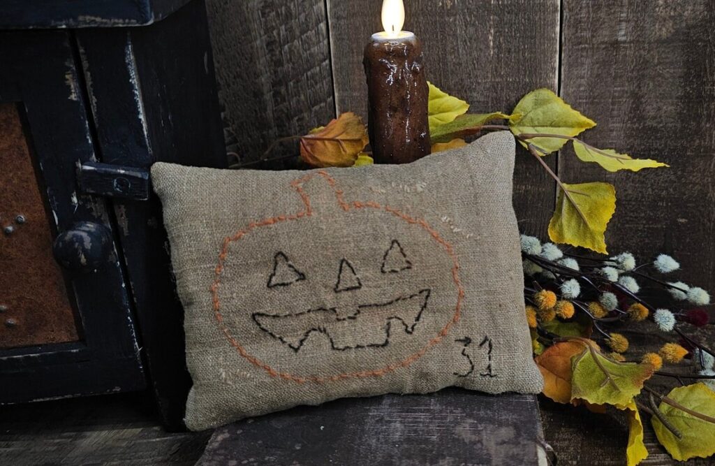 Rustic Halloween pillow tuck with freehand “31” and attic‑style aged finish.