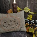 Rustic Halloween pillow tuck with freehand “31” and attic‑style aged finish.