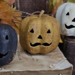 Primitive Jack‑O‑Lantern stack with Dark Mustard head on stacked fabric cushions and real wood slice base