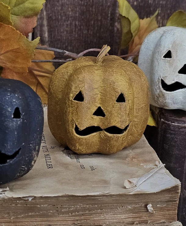 Primitive Jack‑O‑Lantern stack with Dark Mustard head on stacked fabric cushions and real wood slice base