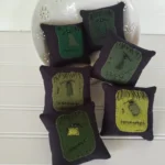 Primitive wool Frankenstein bowl fillers with stitched faces and black button eyes.