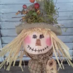 Primitive scarecrow nodder sewing pattern with stitched face and rustic fall details