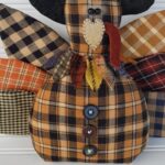 Close‑up of primitive homespun Thanksgiving turkey showing weighted boxed bottom, homespun fabrics, and rustic aged finish.