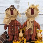 Side‑by‑side close‑up of primitive fall plaid and fall ticking homespun fabrics used for scarecrow body options