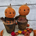 Primitive pumpkin shelf sitters in faux rusty pots showing both stitched mouth options: straight‑line and zig‑zag