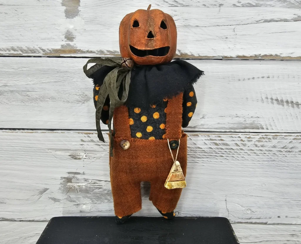 Primitive Halloween Jack‑O‑Lantern sewing pattern with stitched pumpkin face and candy corn accents