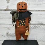 Primitive Halloween Jack‑O‑Lantern sewing pattern with stitched pumpkin face and candy corn accents