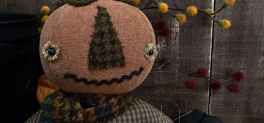 Handmade primitive pumpkin man with removable rusty Jack‑o‑lantern pin and fall accents
