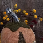 Close‑up of Oliver’s real dried pumpkin stem with wool leaf and aged painted head top