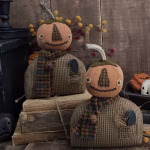 Primitive pumpkin man Oliver with aged painted head, wool scarf, and wooden crow in pocket