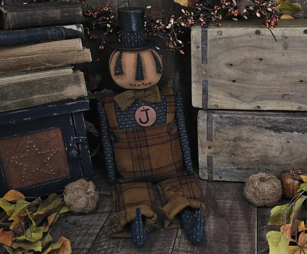 Primitive Jack O’Lantern doll with removable tophat, stitched face, and wool overalls