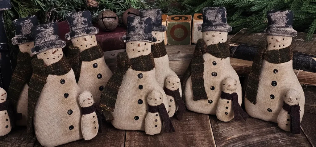 Primitive folk art snowman tuck with attached snow buddy, aged osnaburg fabric, wool scarves, and painted accents.