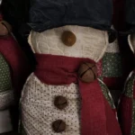 Primitive quilted snowman, Variant E, made from mixed vintage quilt colors and worn patchwork textures; letter E shown on photo.