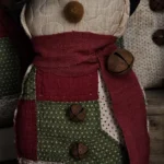 Primitive quilted snowman, Variant B, crafted from repurposed patchwork quilt with darker red and green sections; letter B visible on photo.