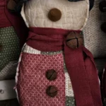 Primitive quilted snowman, Variant C, featuring lighter cream and red quilt patches and rustic textures; letter C shown on photo.