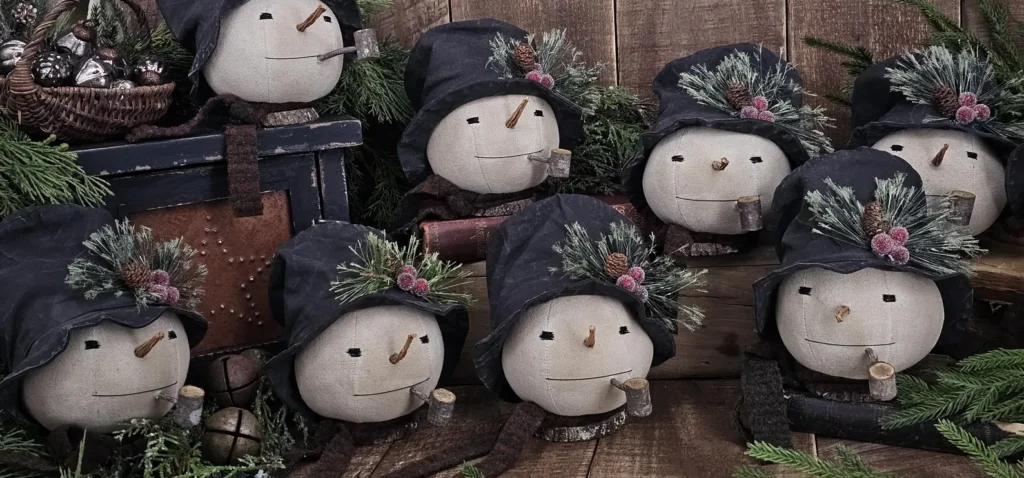 Handmade primitive Jack Frost snowman shelf sitter with tall hat, wool scarf, wood pipe, and tree slice base.