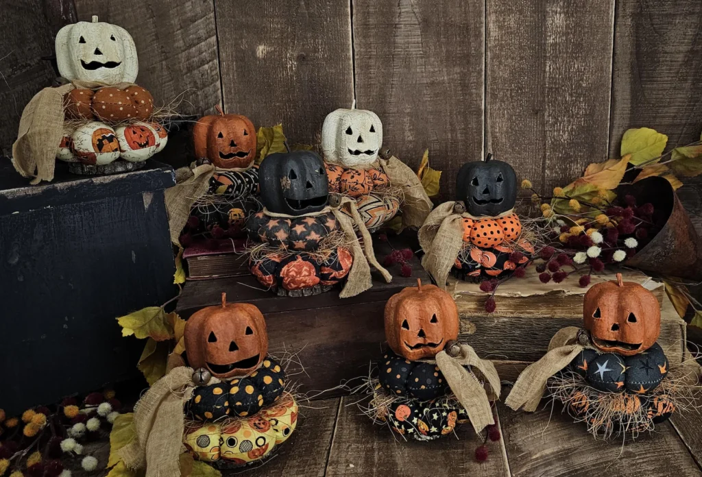 Primitive Jack‑O‑Lantern stack with aged paper‑mâché head and real wood slice base.