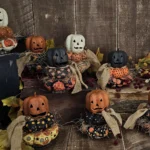 Primitive Jack‑O‑Lantern stack with aged paper‑mâché head and real wood slice base.